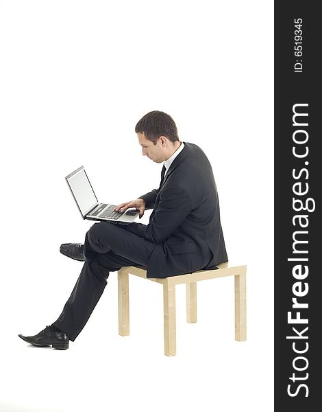 Young businessman sitting with notebook. Young businessman sitting with notebook