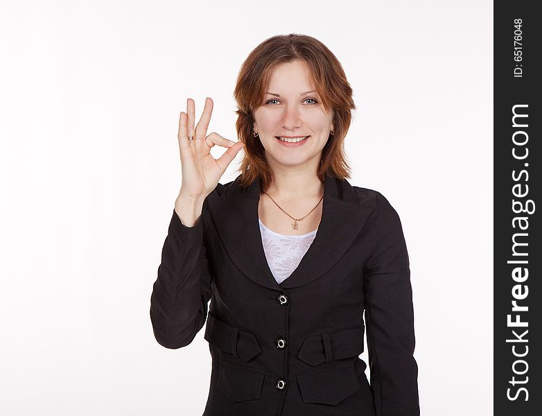 Smiling pretty business woman in black suit showing a gesture all is good. Smiling pretty business woman in black suit showing a gesture all is good