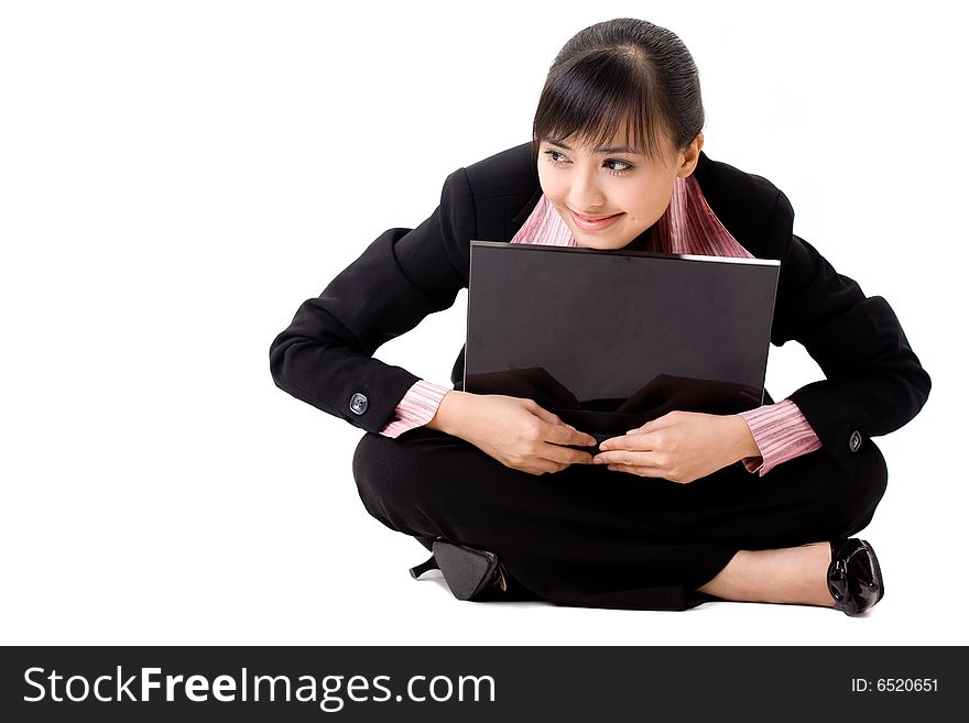 Pleasant looking asian business woman sitting with a laptop. Pleasant looking asian business woman sitting with a laptop