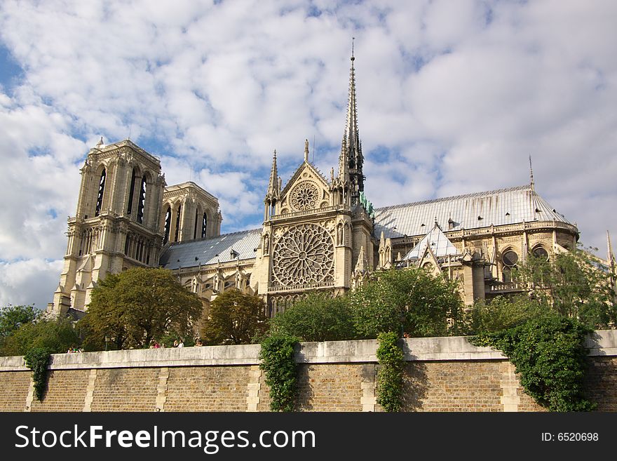 Notre Dam cathedral of Paris, horizontal, blue sky and trees