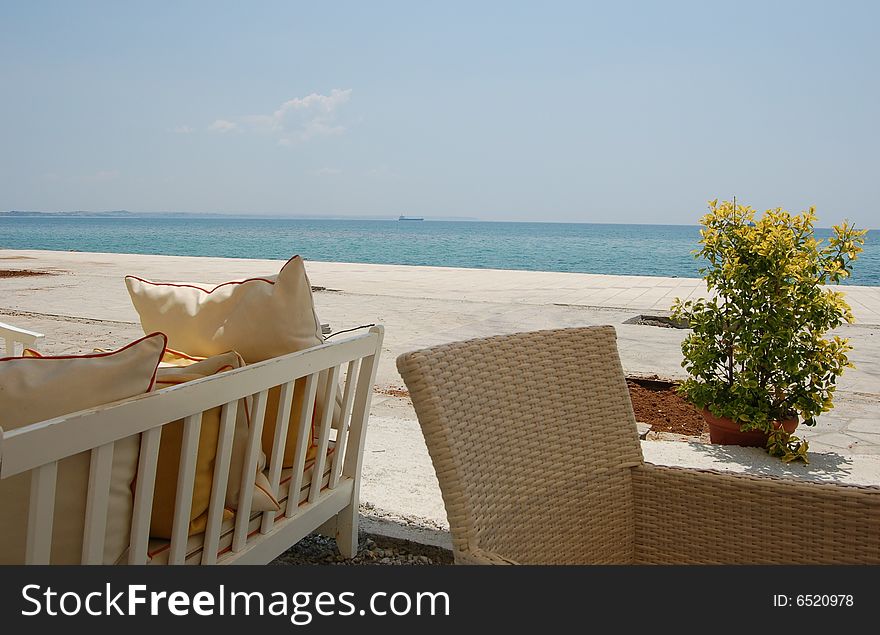 A beach with a white sand and chairs ready for relax. A beach with a white sand and chairs ready for relax