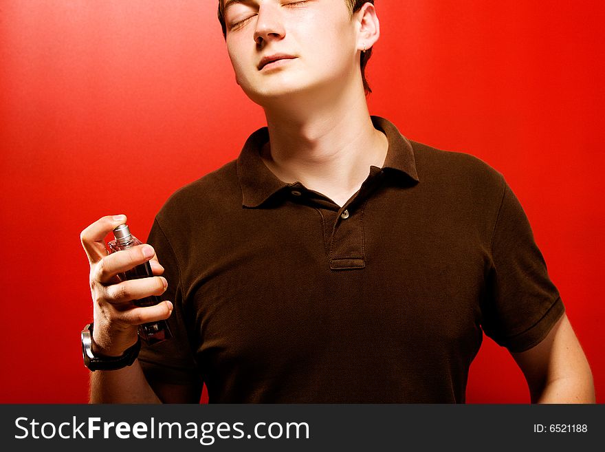 Young pensive man over red background