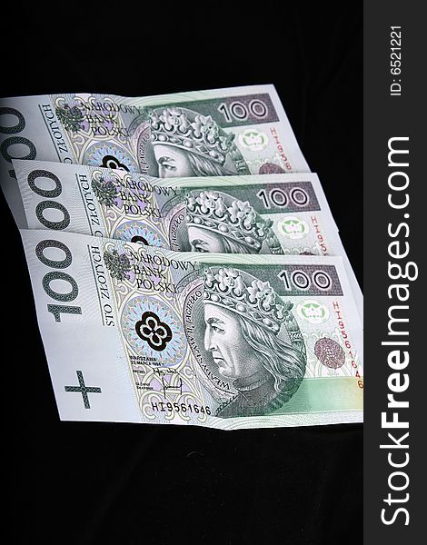 Polish currency, 100 zloty banknotes, over black