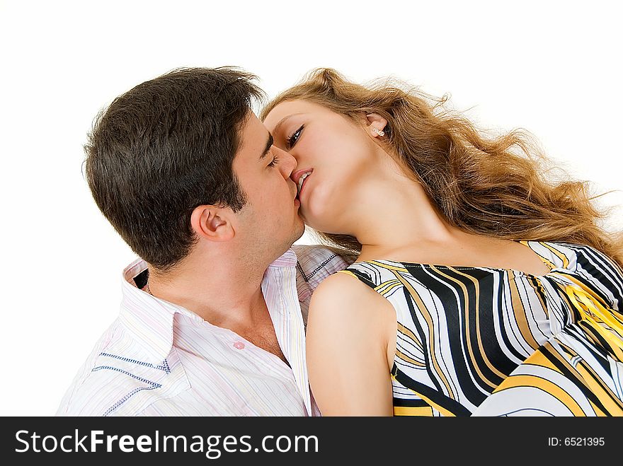 Kissing young couple with open eyes on white background. Kissing young couple with open eyes on white background