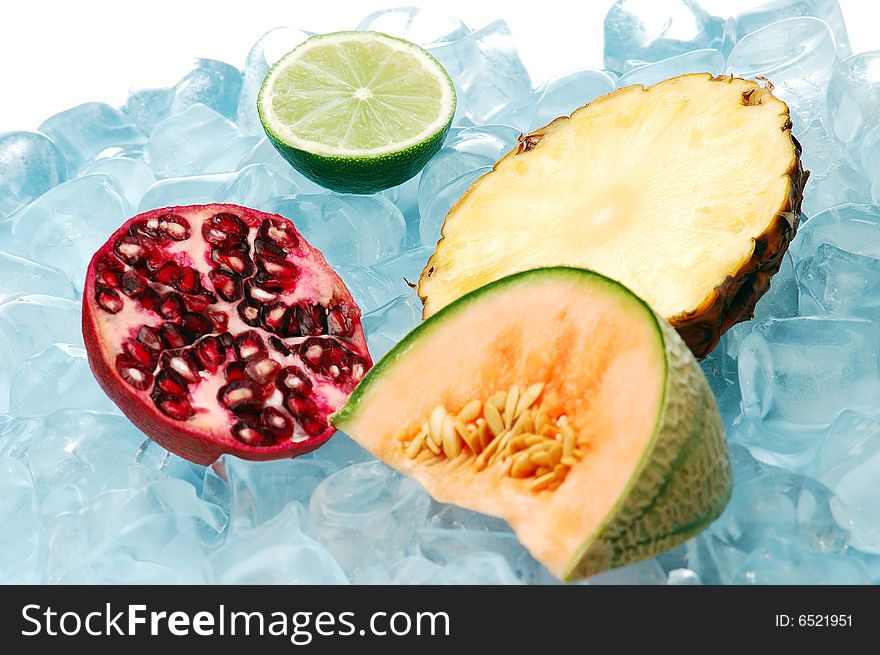 Tropical fruits on ice on white background