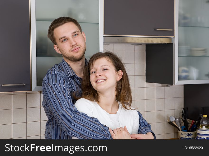 Happy couple together in kitchen