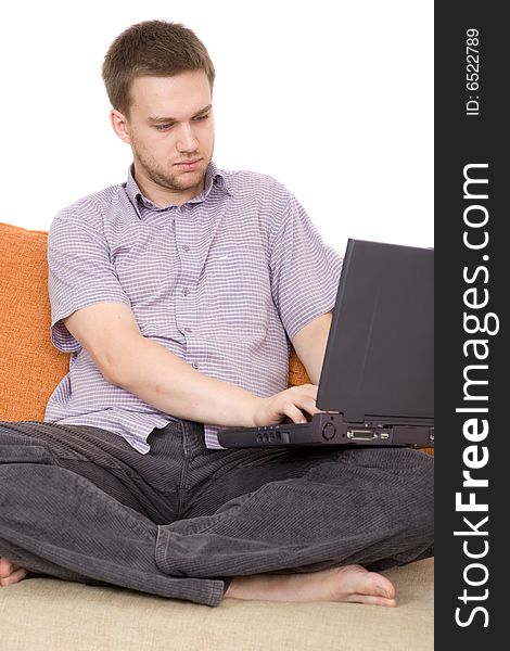 Casual guy sitting on sofa with laptop. Casual guy sitting on sofa with laptop