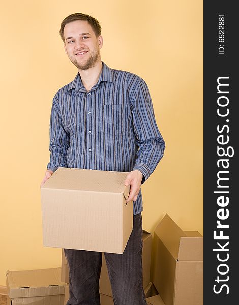 Happy man with boxes moving in