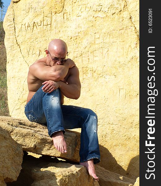 Strong bald man in thinking pose. Strong bald man in thinking pose