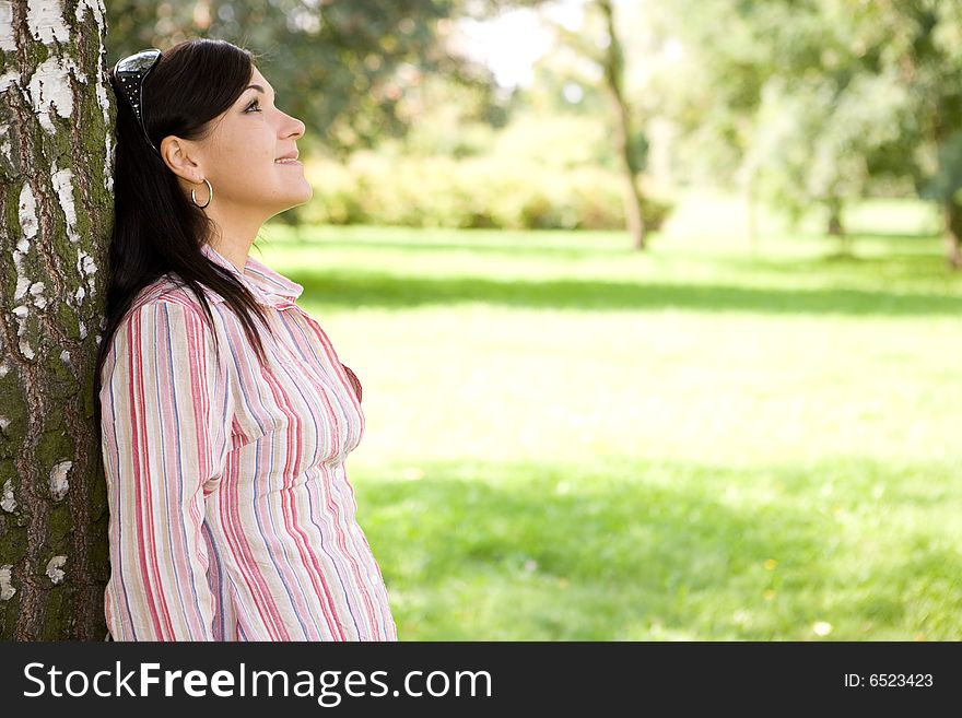 Attractive brunette woman in park. Attractive brunette woman in park