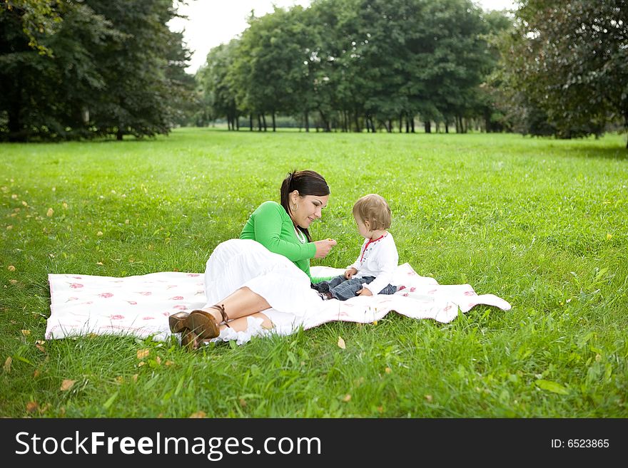 Happy family playing in park. Happy family playing in park