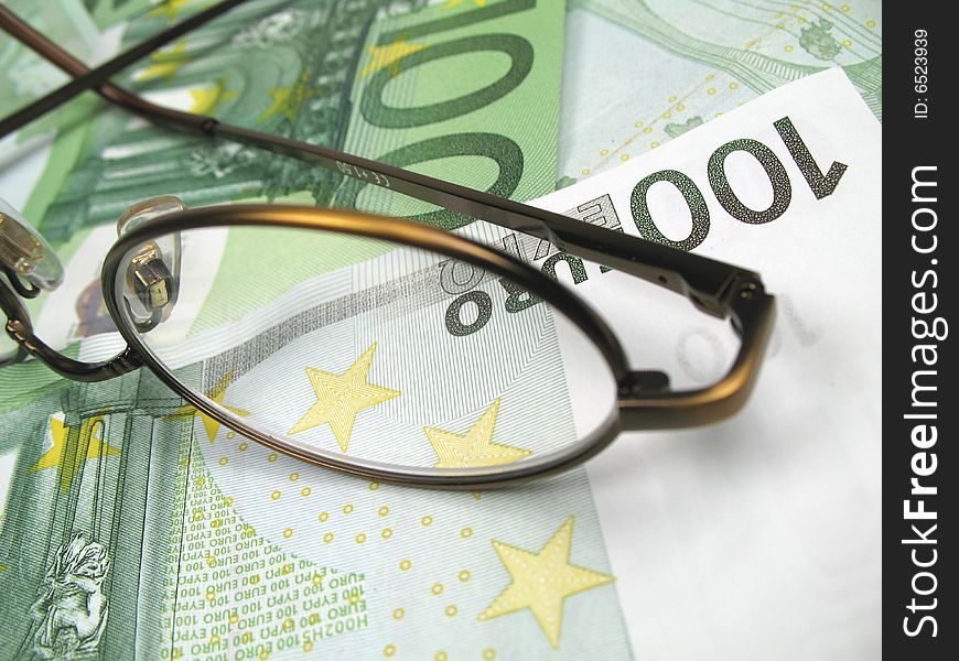 A pair of glasses on a hundred euro banknote. A pair of glasses on a hundred euro banknote