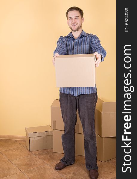 Happy man with boxes moving in