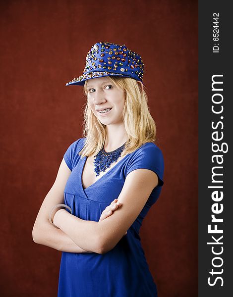 Teenage girl with braces wearing a hat with sequins. Teenage girl with braces wearing a hat with sequins