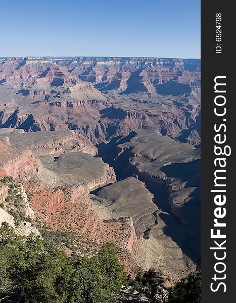 Grand Canyon with green trees and blue sky