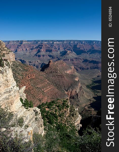 Morning sunrise at the Grand Canyon with blue sky