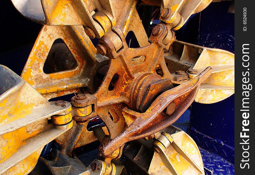 A rusty piece of metal equipment from an unknown machine. A rusty piece of metal equipment from an unknown machine