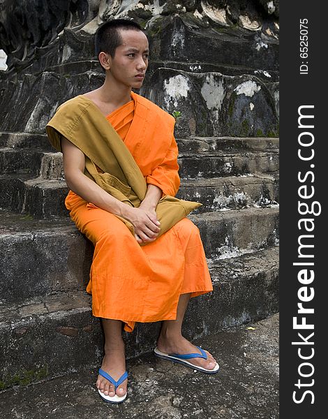 Buddhistic monk in Luang Prabang, Laos with orangener clothes