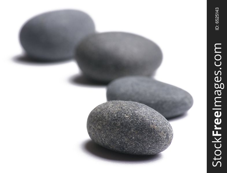 Four smooth stones on white background