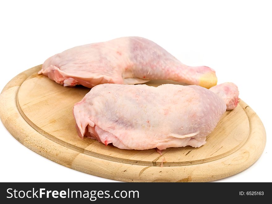 Fresh chicken legs-drumsticks-on the cutting board.