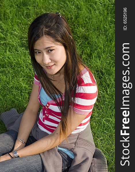 Young Asian Woman sitting on the grass