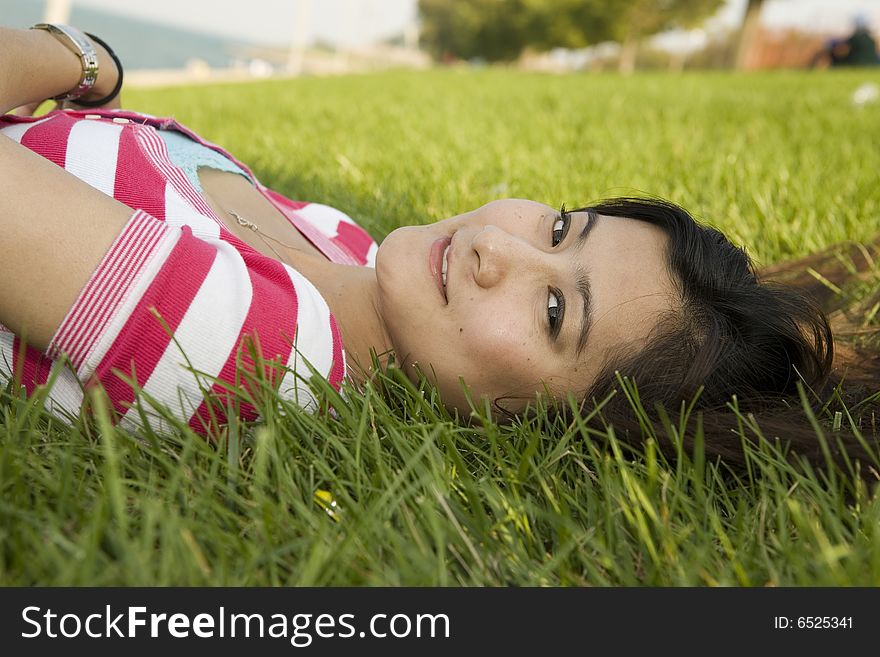 Young Asian Woman lying on the grass