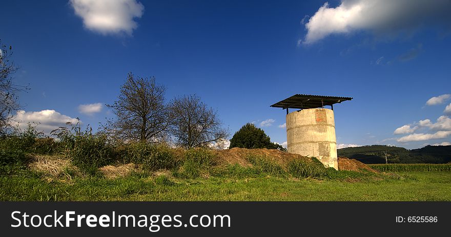 A granary with a blue sky and green grass