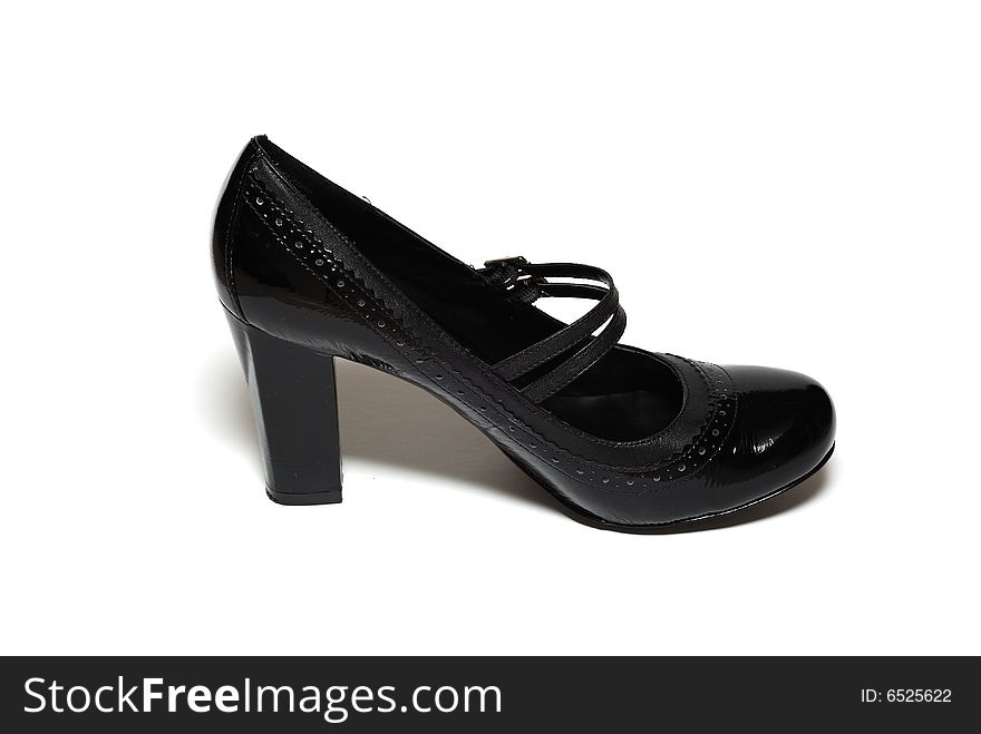 A picture of one high heel black shoe