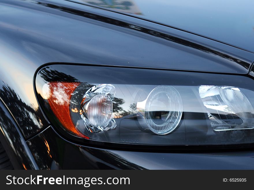 Abstract composition of car details: headlight and wheel