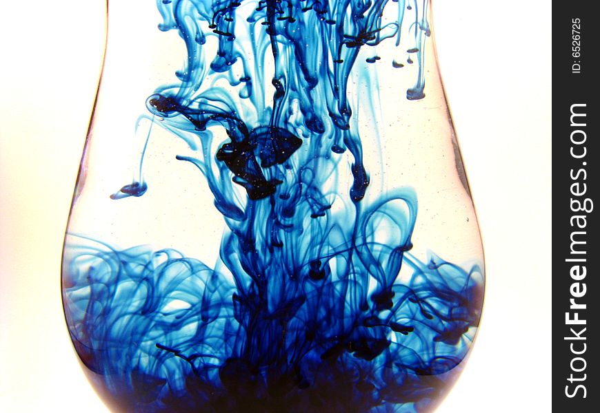 An abstract shot of swirls of blue within clear liquid. An abstract shot of swirls of blue within clear liquid