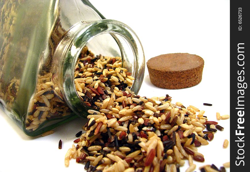 Long grain wild rice spilling from a jar