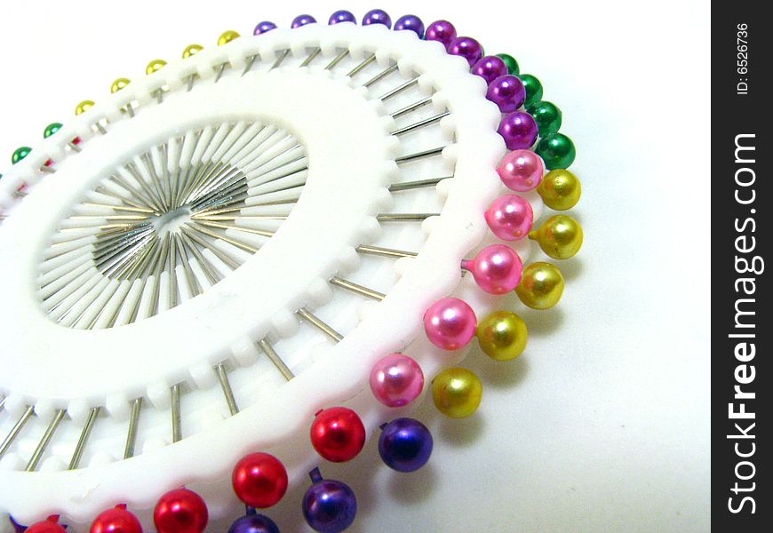 A wheel of multi-colored straight pins. A wheel of multi-colored straight pins