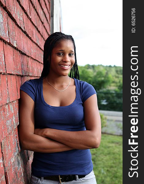 Pretty teen standing against red weathered shingles. Pretty teen standing against red weathered shingles