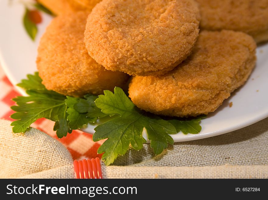 Pieces of chicken empanadas and roasted, on the table, decorated with parsley. Pieces of chicken empanadas and roasted, on the table, decorated with parsley