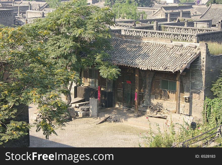 Ancient city Pingyao in China,there is courtyard,old house and trees in the courtyard. Ancient city Pingyao in China,there is courtyard,old house and trees in the courtyard.