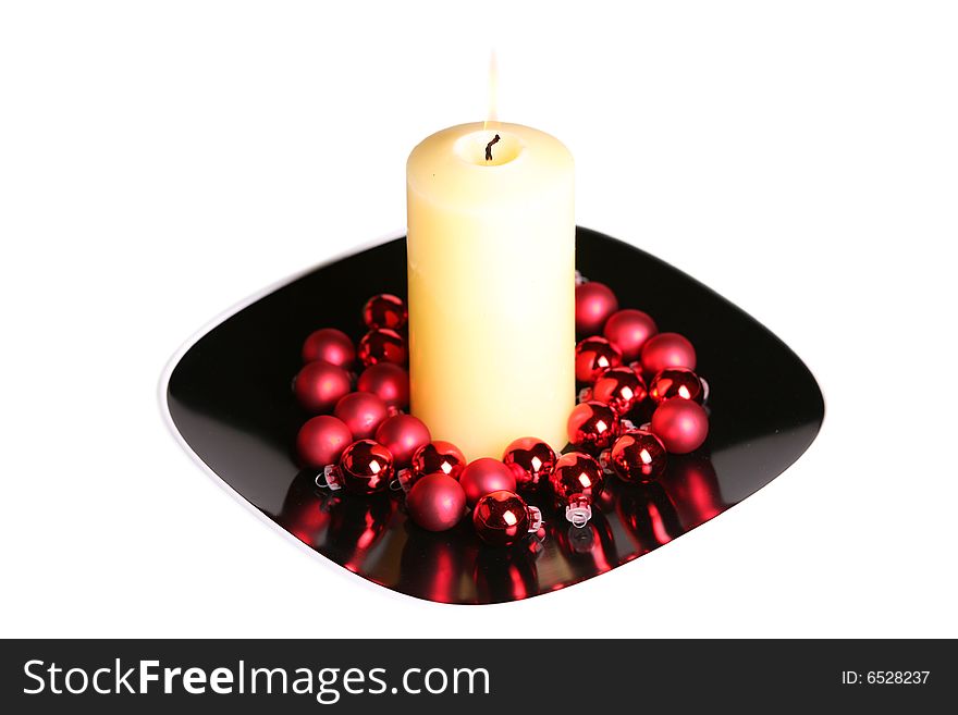 Large white candle burning in holiday setting