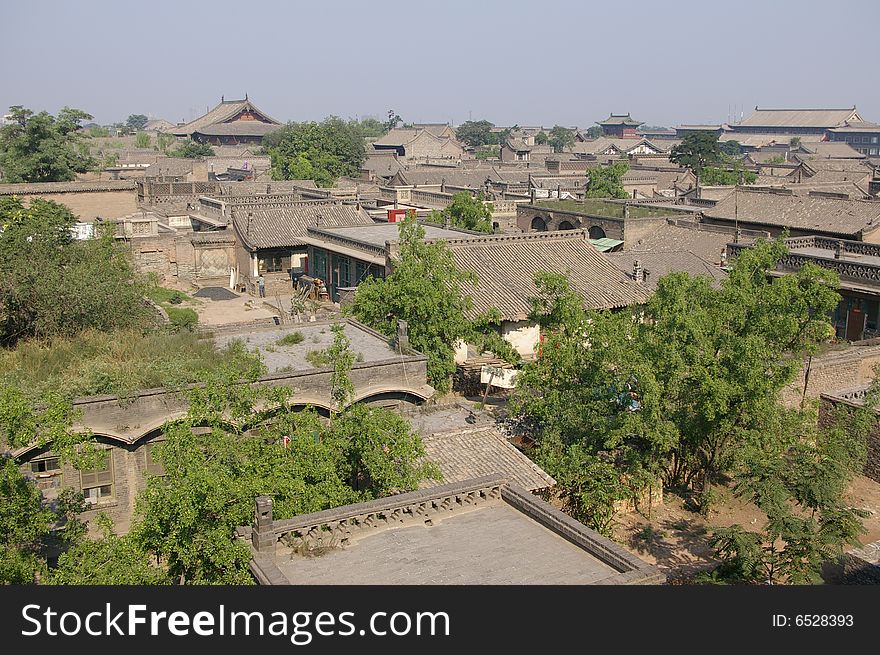 Ancient city Pingyao in China,old house and trees in the town. Ancient city Pingyao in China,old house and trees in the town.