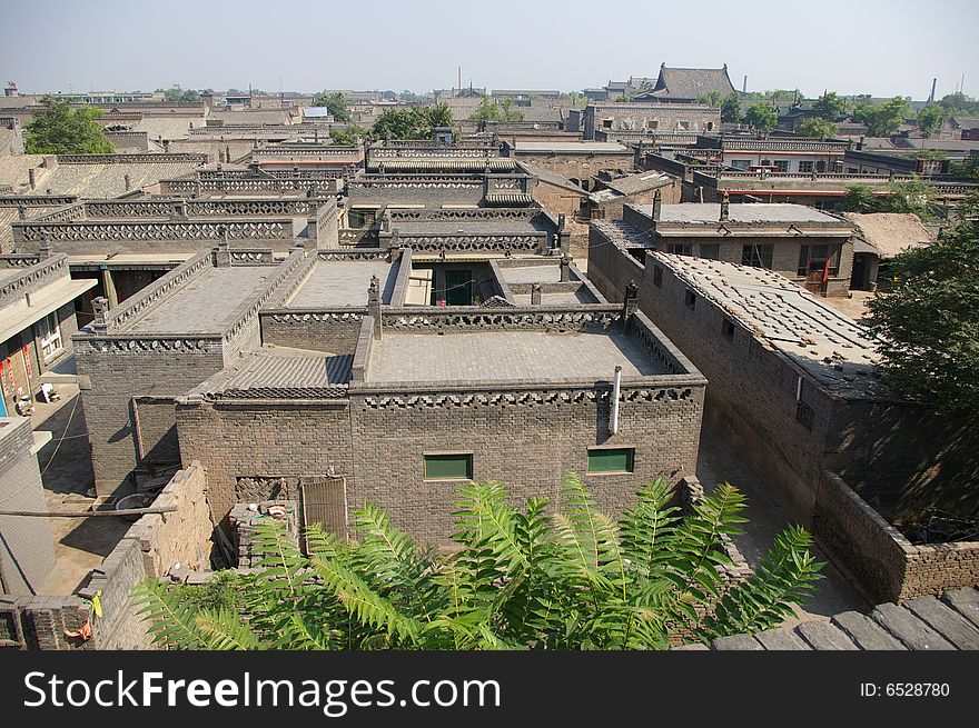 Ancient city Pingyao in China,old house and trees in the town. Ancient city Pingyao in China,old house and trees in the town.