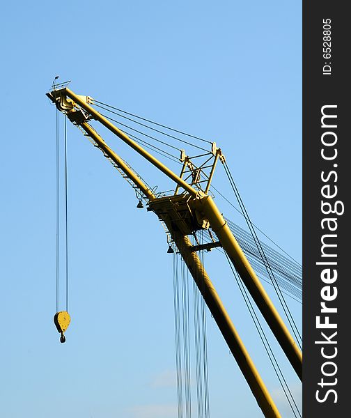 Yellow construction crane and blue sky