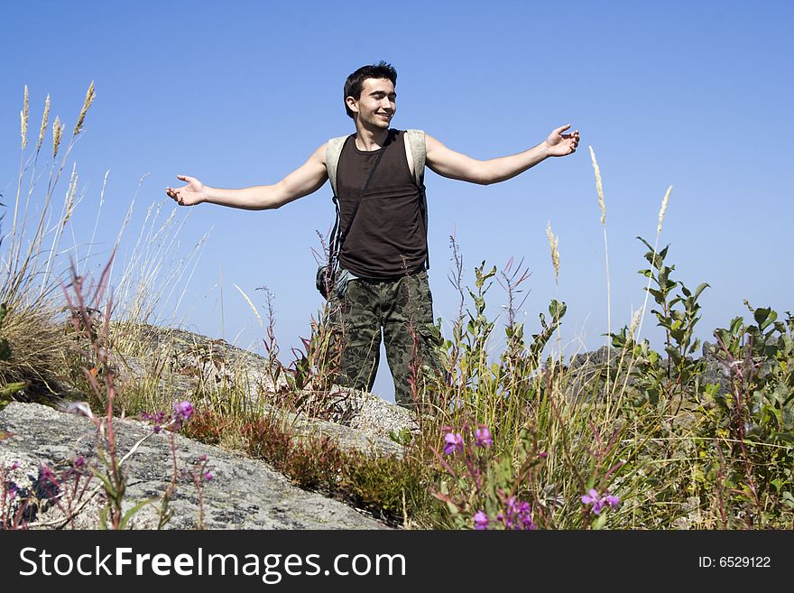 A beautiful boy enjoying the nature in the mountain. A beautiful boy enjoying the nature in the mountain