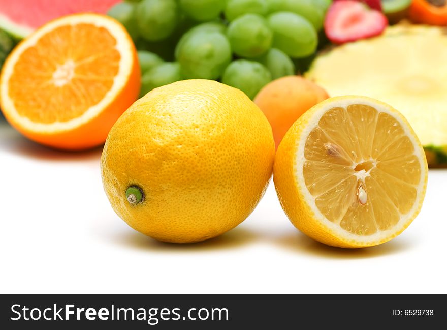 Slice lemon on fruits background