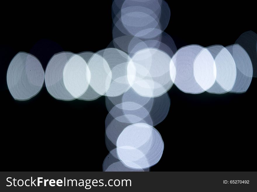 This is an cross of abstract white light bokeh. This is an cross of abstract white light bokeh