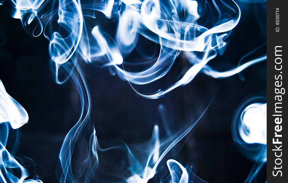 Abstract blue smoke isolated on black