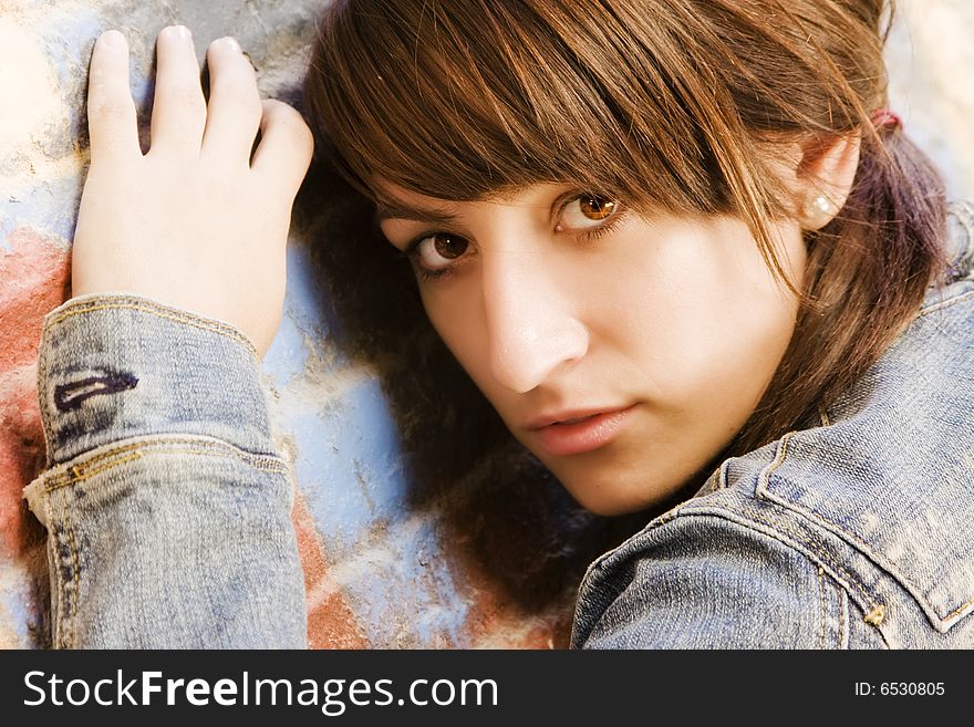 Young Woman On Brickwall