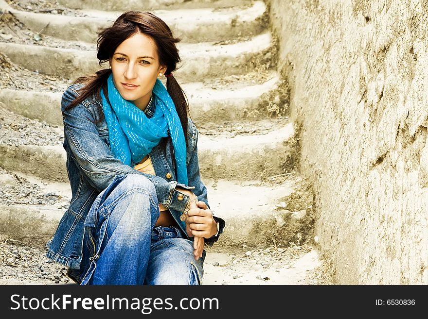 Young woman on stone stairs