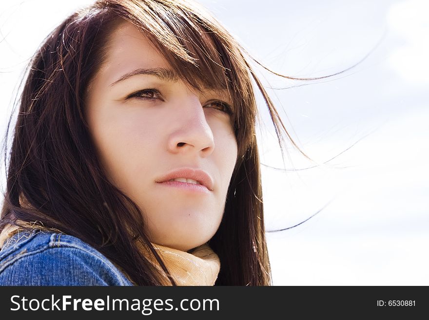 Close woman portrait with her hair on the wind.