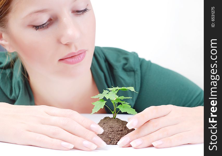 Beautiful young woman with green sprout of tree. Beautiful young woman with green sprout of tree