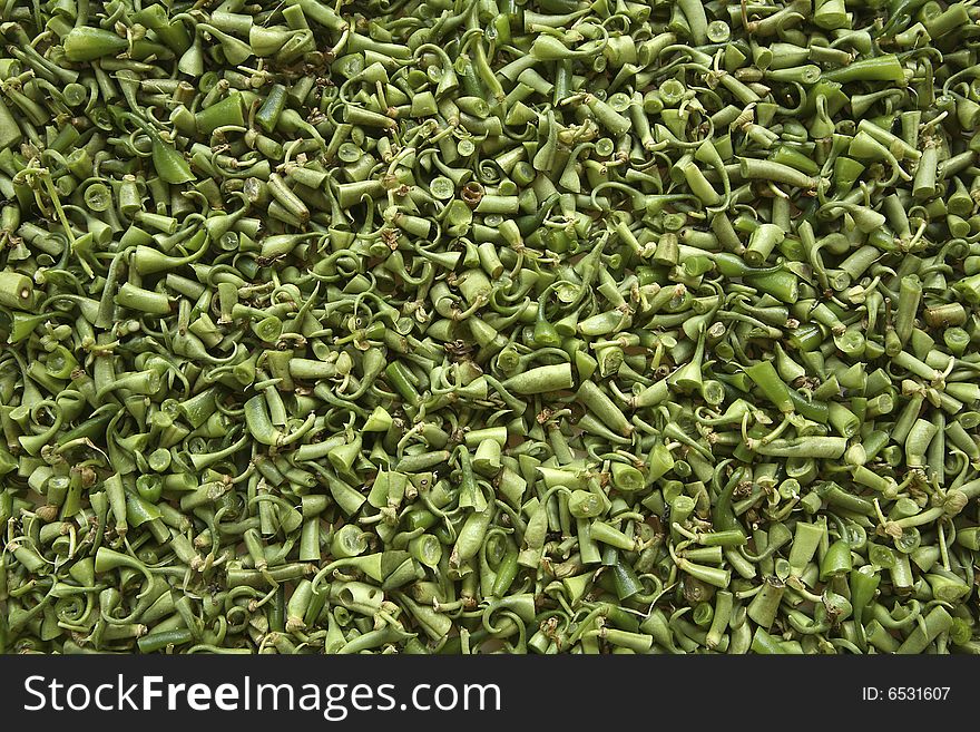 Mass of green bush bean tops and tails abstract background. Mass of green bush bean tops and tails abstract background.