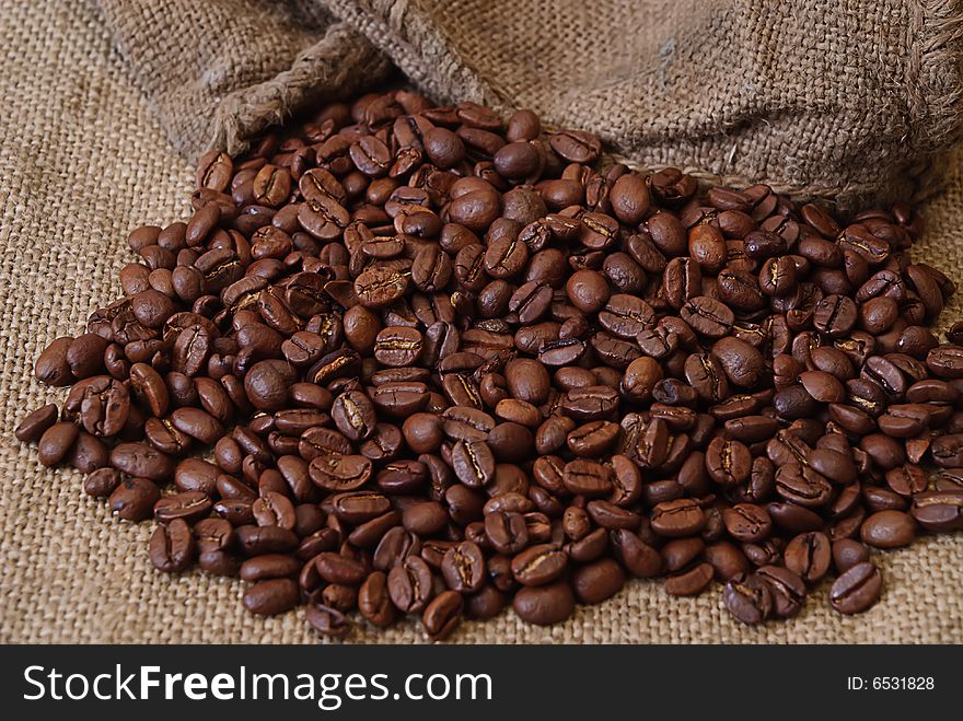 Black arabic coffee in rough sack close up. Black arabic coffee in rough sack close up