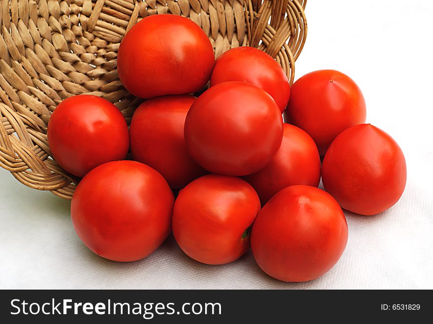 Red tomato and hand made wooden basket